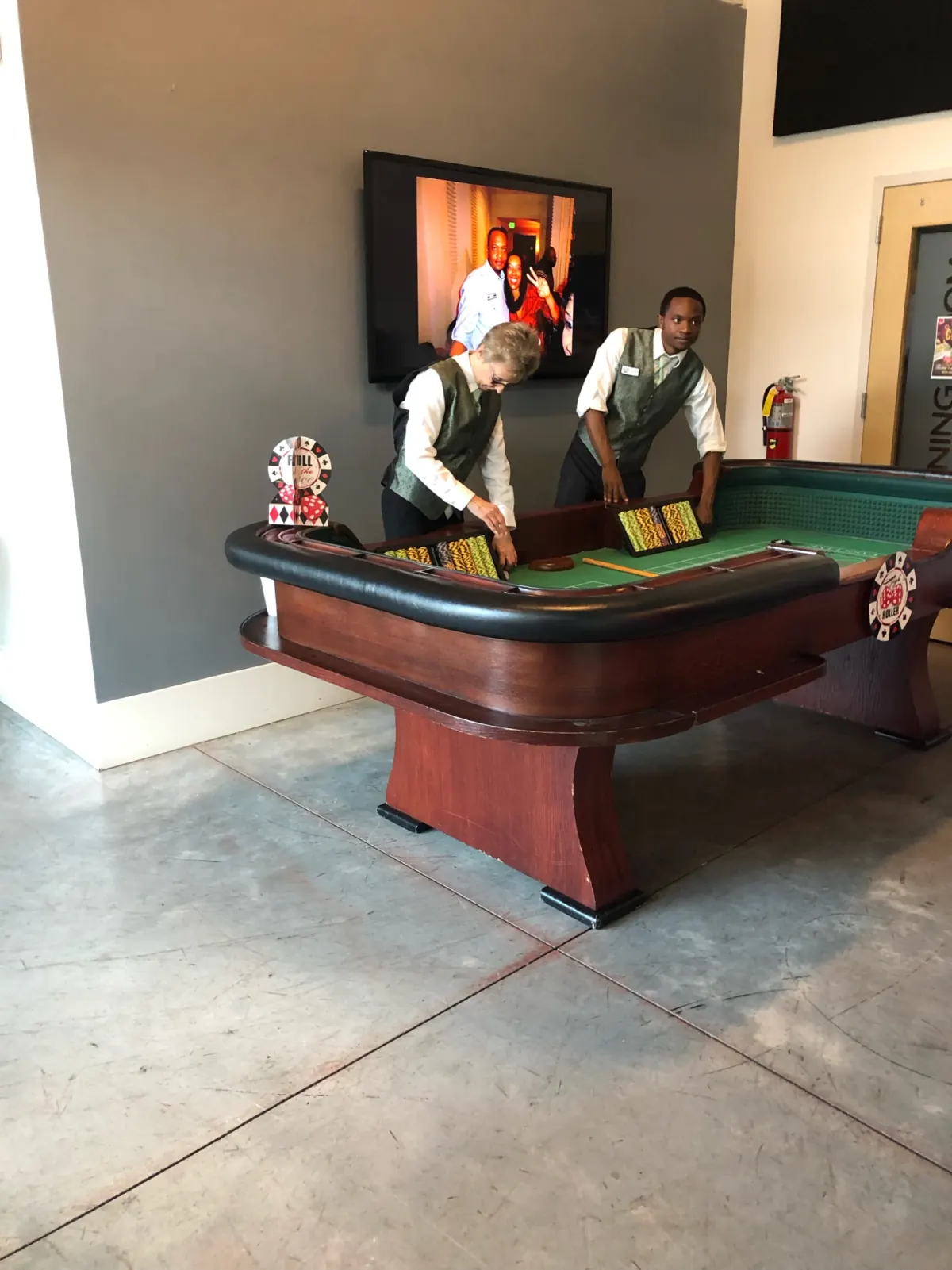 Casino-themed event with a craps table and dealers in vests