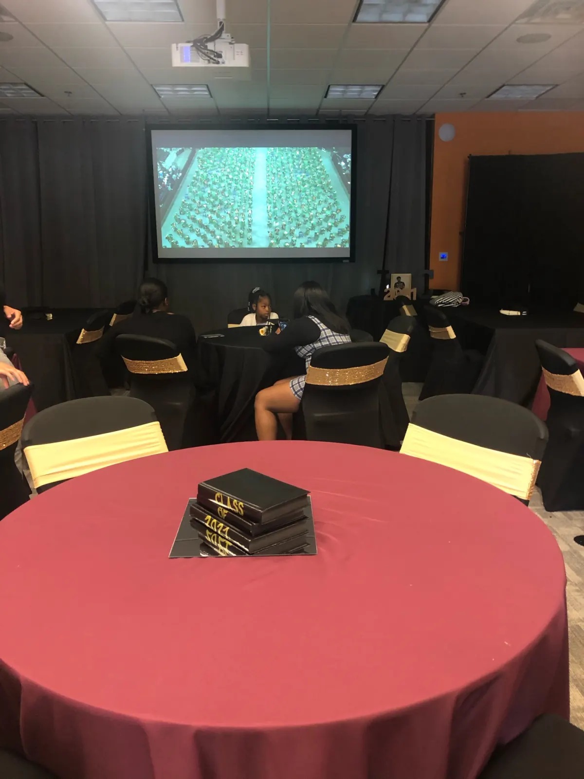Graduation watch party with banquet seating and projector screen